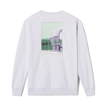 White long-sleeve shirt with a graphic of a building and palm trees on the back, on a white background.